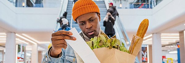 man with groceries and receipt